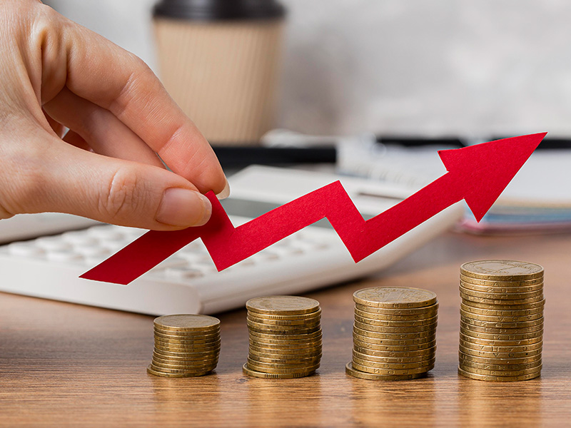 mano-que-sostiene-la-flecha-de-crecimiento-con-monedas